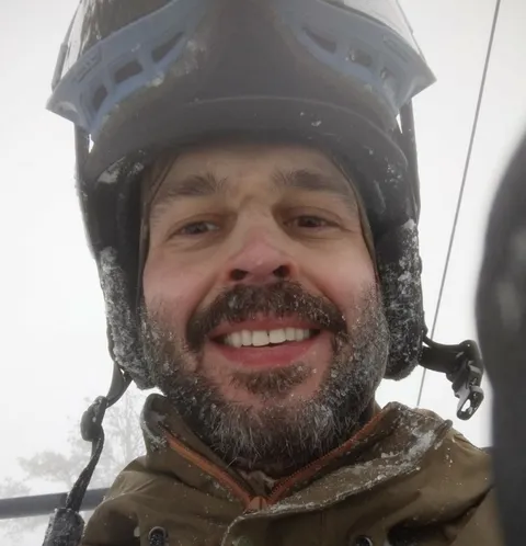 Aleksandr Oreshkin outdoors in a snow-covered helmet